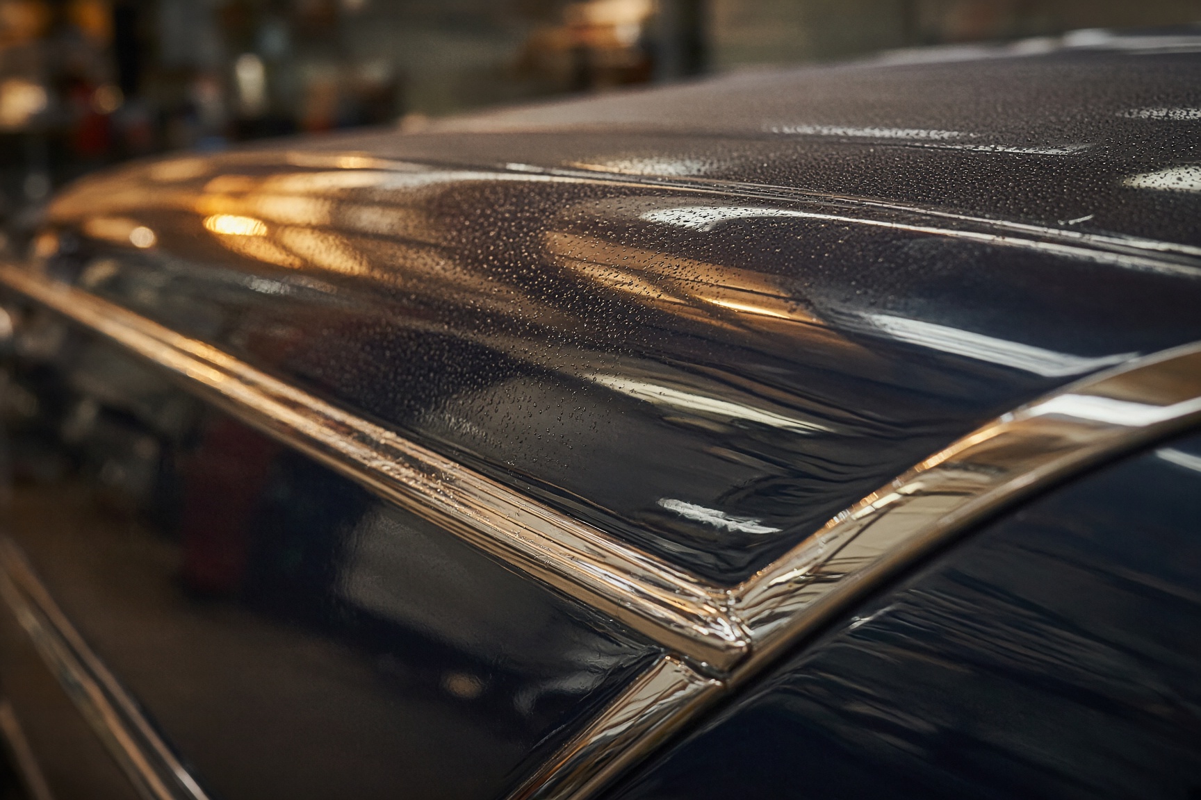 Chrome trim and dark paint in workshop light